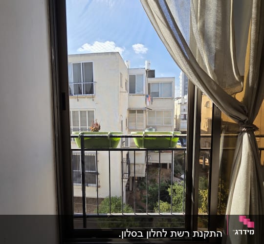 התקנת רשת לחלון בסלון.